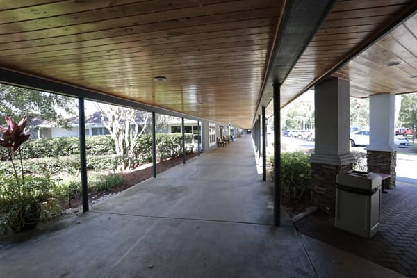 Covered walkway with seating and landscaping