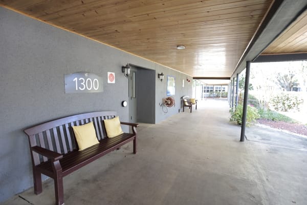 Covered walkway with seating and signage