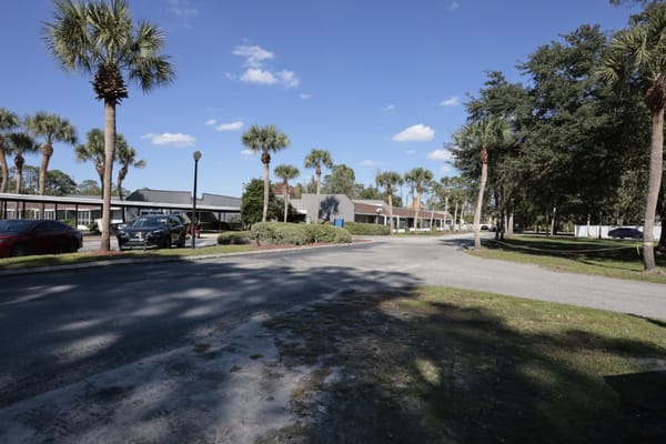 Pathway leading through a landscaped area of the facility