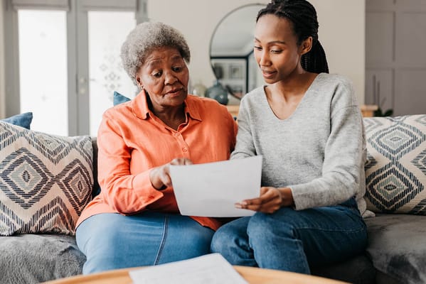 A resident and caregiver reviewing documents together