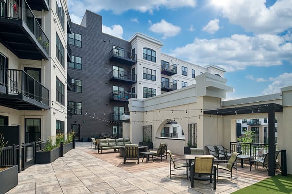 Outdoor lounge area with seating and string lights