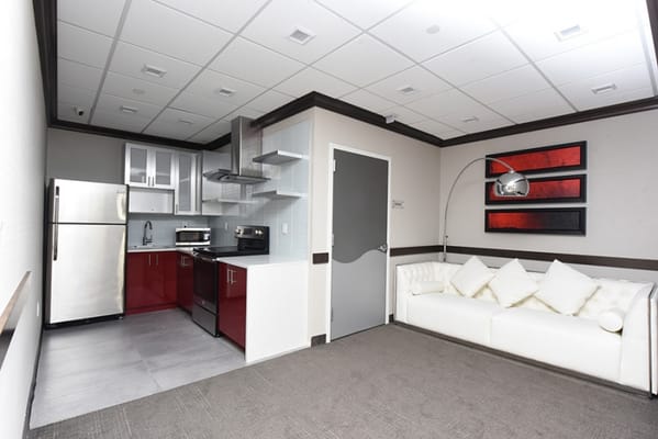 A modern interior space with kitchen and seating area