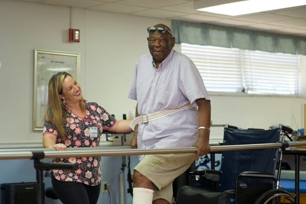 Staff assisting a resident during therapy session