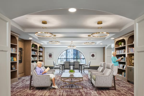 Residents enjoying a cozy common area with books
