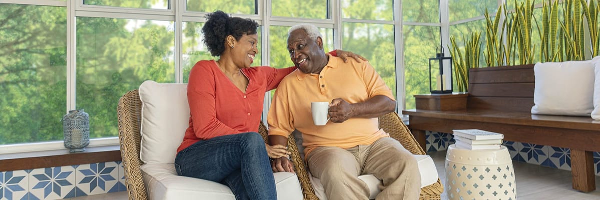 Two residents enjoying conversation in a common area