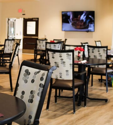 Dining area with tables and a television