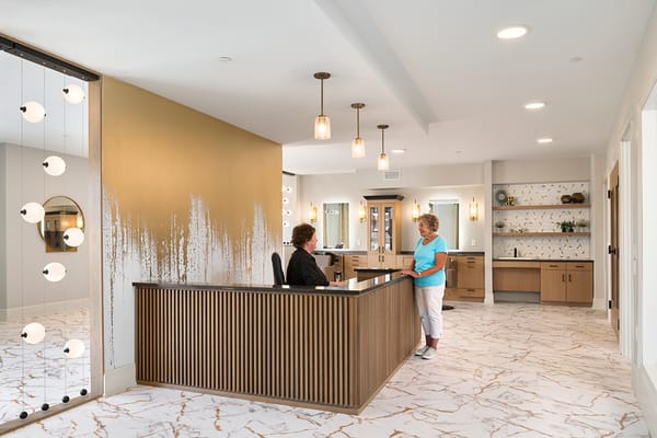 Reception area with staff assisting a resident.