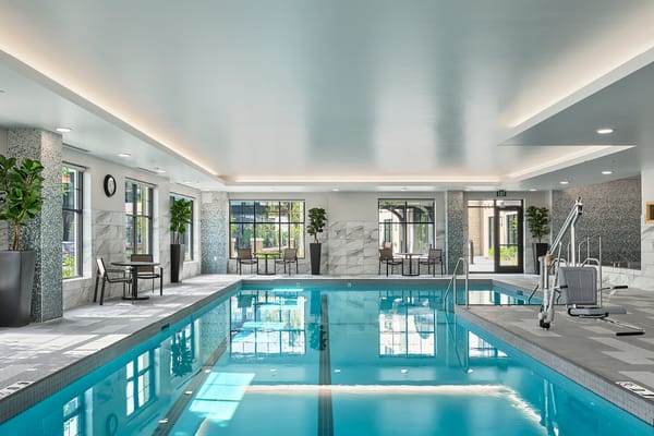 Indoor swimming pool area with seating