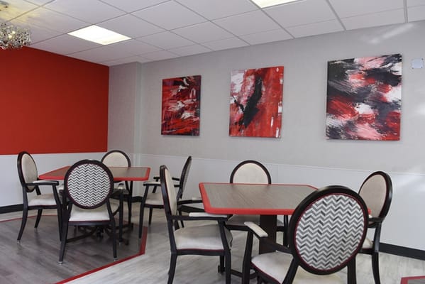 Bright dining area with abstract art on the walls