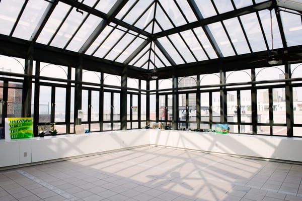 Bright sunroom with large windows and tiled floor