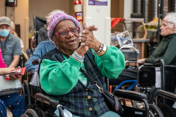 Resident enjoying an activity and clapping hands