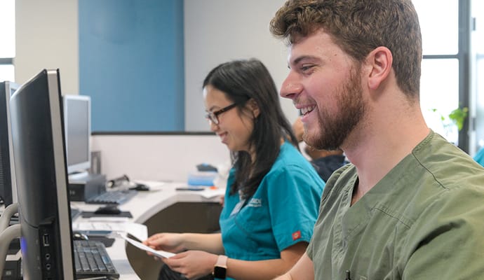 Staff members working at a computer station