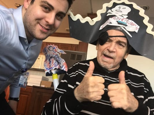 Resident dressed as a pirate giving thumbs up with staff member