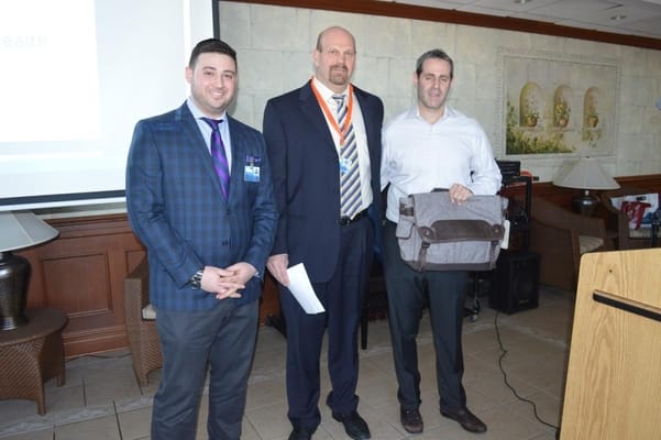 Staff members presenting at an indoor event