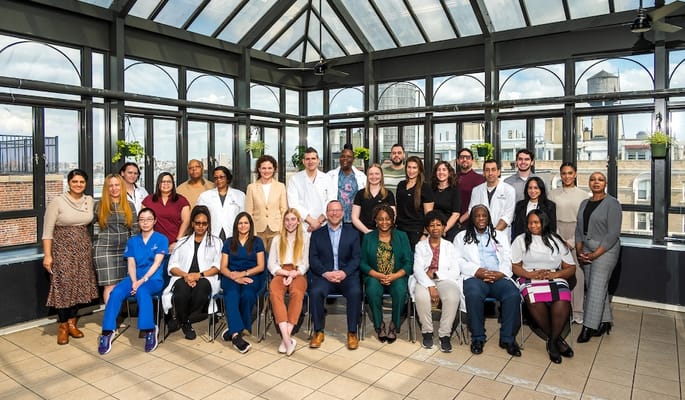 Group photo of staff members in a bright common area