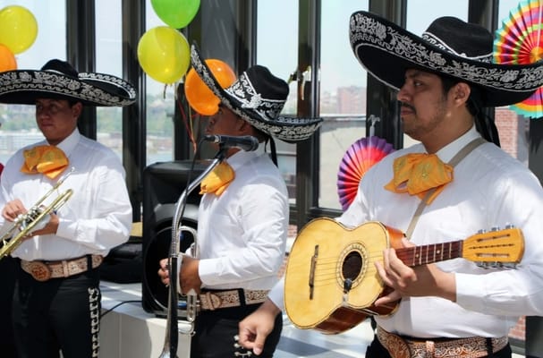 Musicians performing at a facility event with colorful decorations