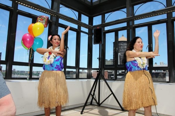 Residents participating in a hula dance performance