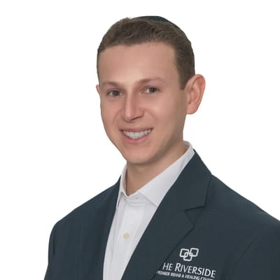 A staff member in a facility blazer