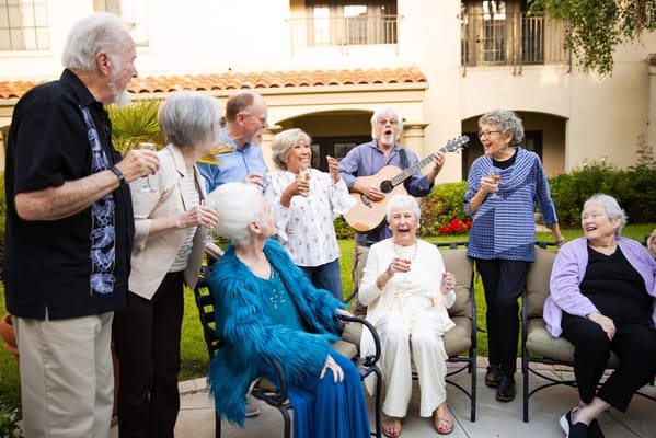 Residents enjoying a musical performance in the garden