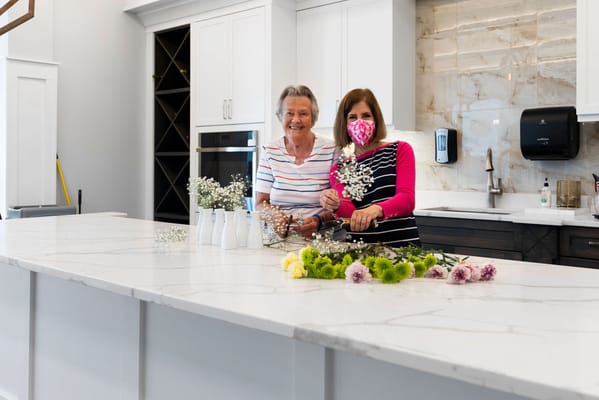 Residents enjoying a flower arranging activity in the kitchen