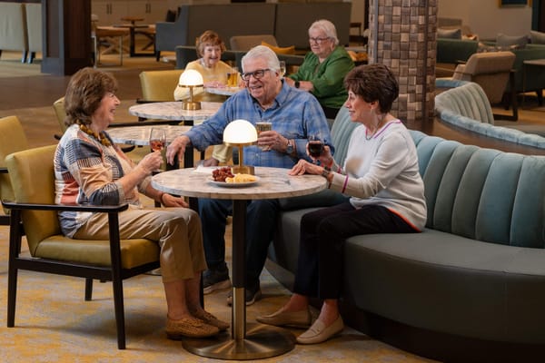 Residents enjoying refreshments in a cozy lounge area