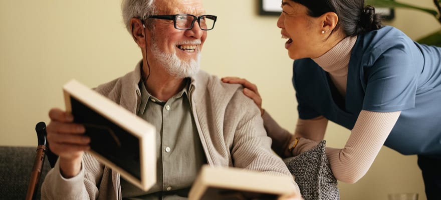 A caregiver interacting joyfully with a resident