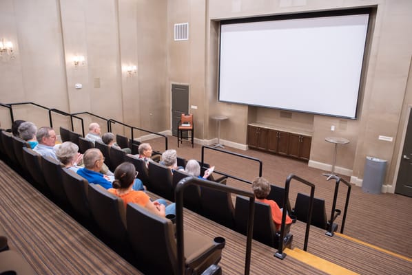 Residents enjoying a movie in a theater room