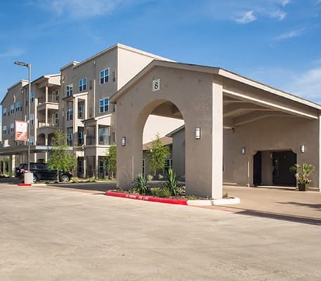 Exterior view of the facility with entrance and parking