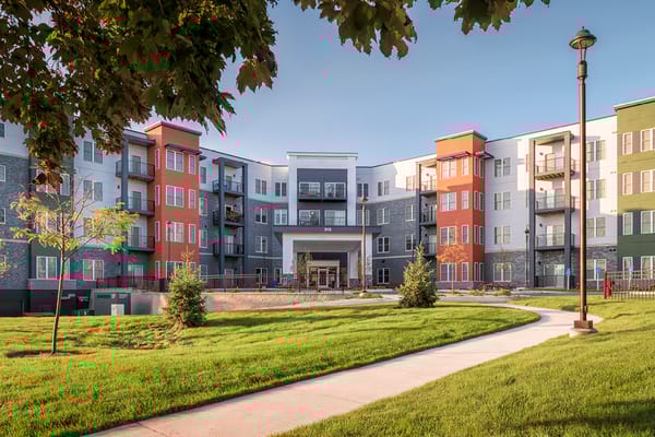 Exterior view of a senior living facility with green space
