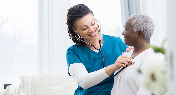 Nurse checking a senior resident's heartbeat