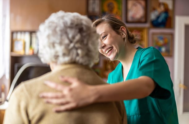 Caregiver interacting with a resident in a warm environment