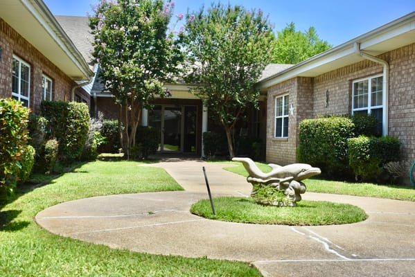 Garden area with landscaping and a stone sculpture