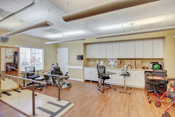 Rehabilitation area with exercise equipment and therapy aids