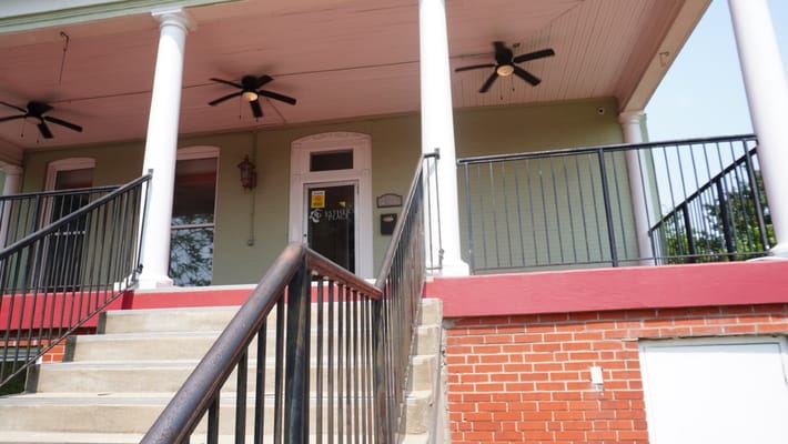Exterior view of the entrance with stairs and fans