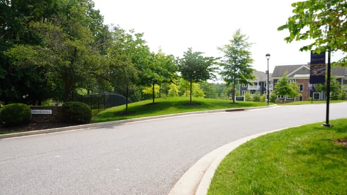 Outdoor space with greenery leading to the facility