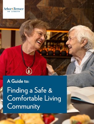 Two elderly women smiling together in a cozy setting