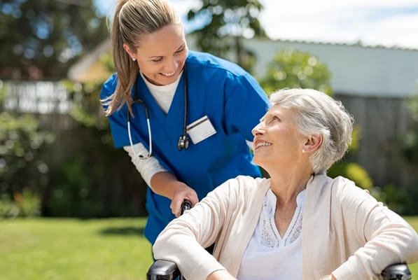 Caregiver assisting a resident in a garden