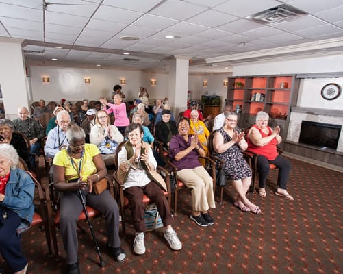 Residents enjoying an activity in a bright community room