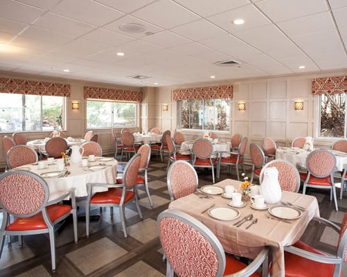 Bright dining room with tables set for meals