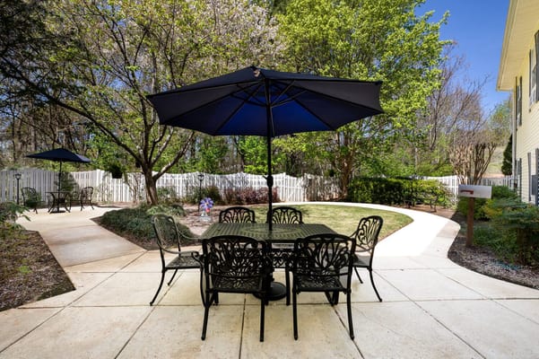Outdoor seating area with umbrellas and greenery