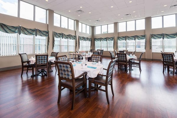 Bright dining room with tables set for meals