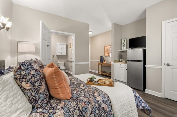 Cozy resident room with a bed and kitchenette