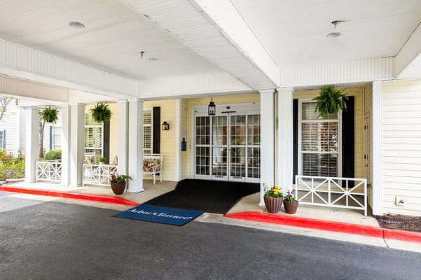 Entrance to Arbor Terrace of Athens facility with planters