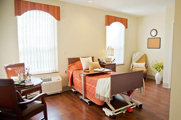 Cozy private room with a bed and chairs