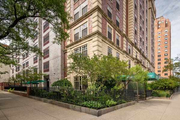 Exterior view of a nursing home building with landscaped garden