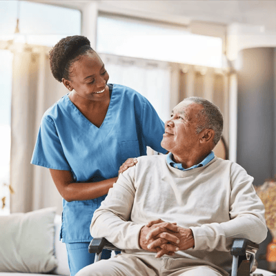 Nurse interacting with a senior resident in a common area