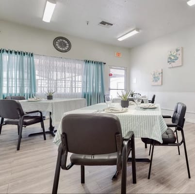 Bright dining room with tables set for meals