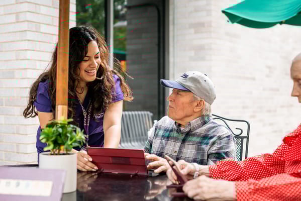 Staff interacting with a resident in an outdoor space