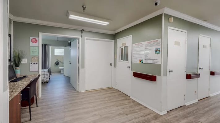Interior hallway with resident rooms and a desk