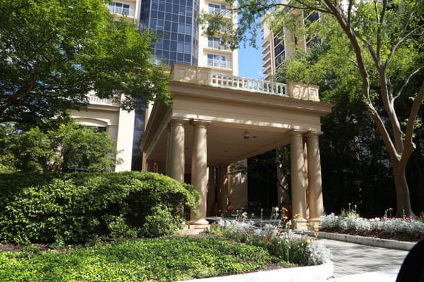 Entrance of Renaissance on Peachtree featuring columns and greenery